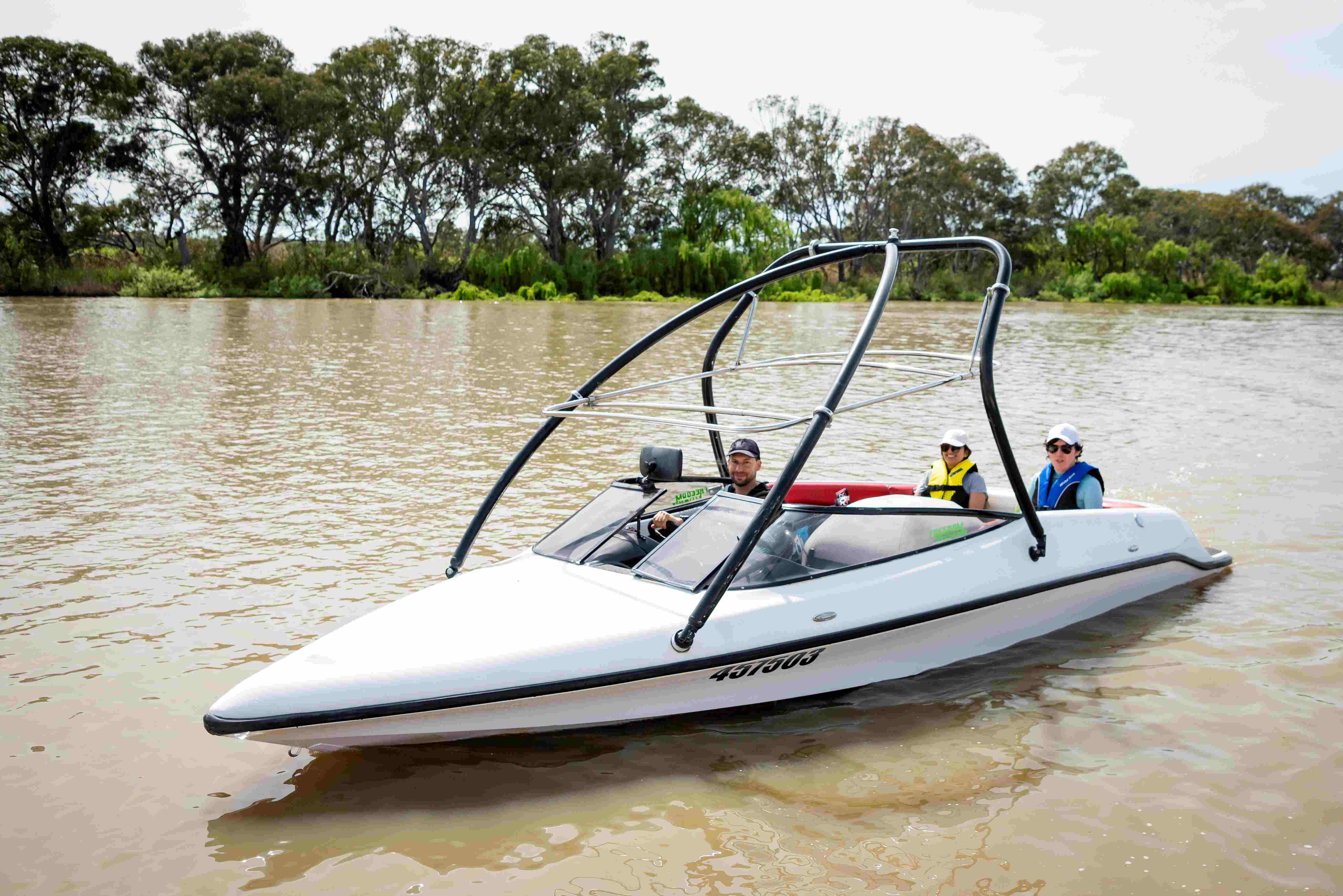 Speed boat on the River Murray with a driver and two passengers 
