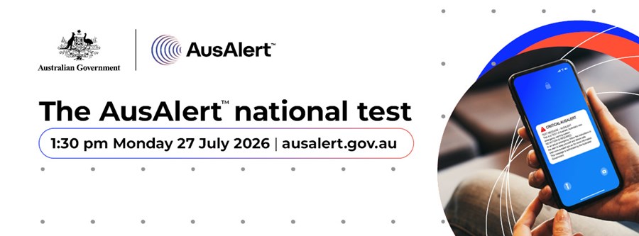 The image is a promotional banner for the Australian Government's AusAlert emergency warning system. The banner features the Australian Government crest and the AusAlert logo at the top. Large bold text in the centre reads “The AusAlert national test”. Below the heading, the banner states that the national test will occur at 1:30 pm on Monday 27 July 2026 and directs readers to ausalert.gov.au for more information. On the right-hand side of the image, a smartphone is shown displaying a sample emergency alert message on a blue screen. Curved red, blue and white graphic elements surround the phone, representing communication and alert networks. The background is light grey with a subtle pattern of small dots. The image promotes the upcoming national test of Australia's emergency alert system, which is designed to send warnings and emergency information to mobile devices during significant incidents and disasters.