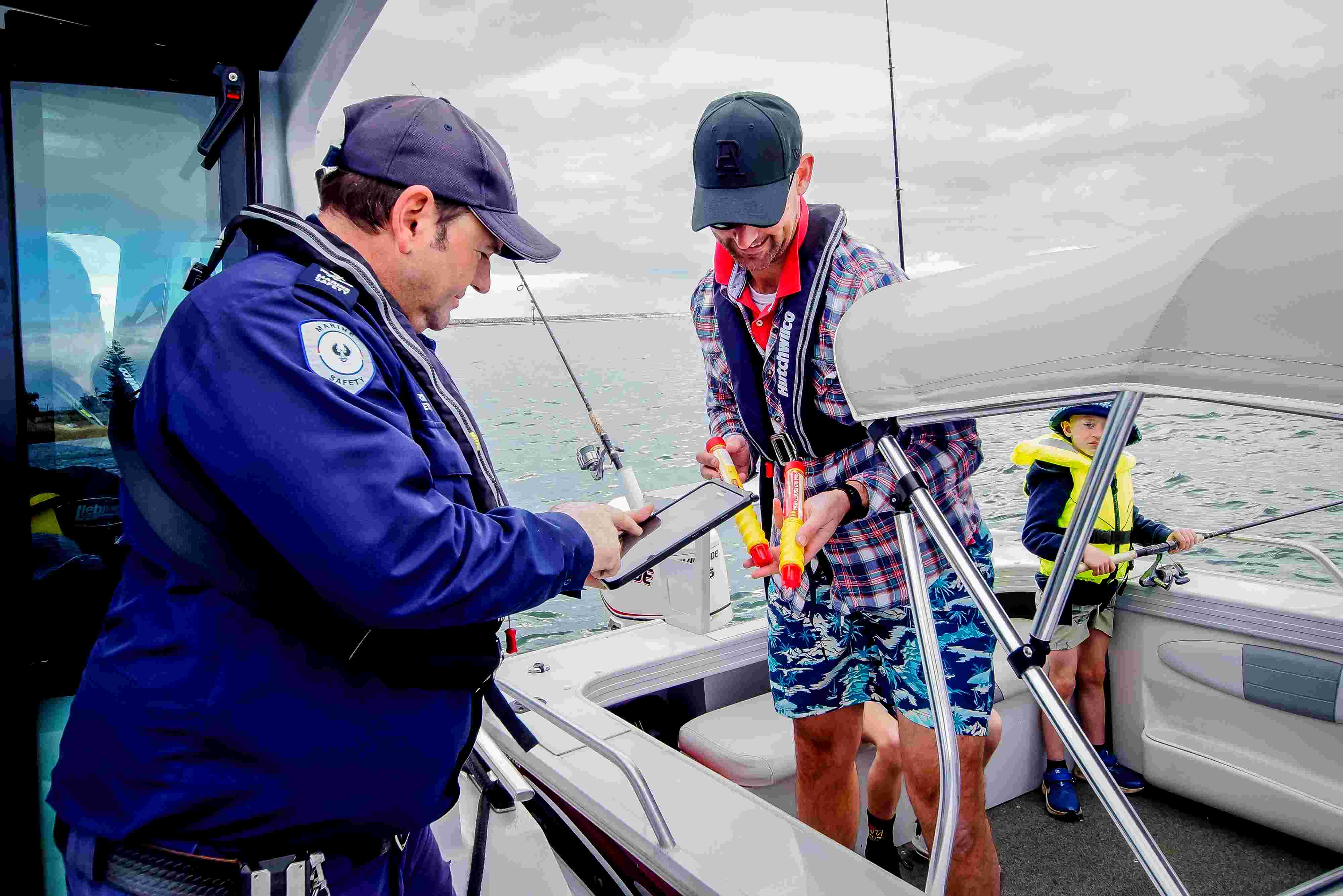 MSO checking that a male has flares on board while boating 