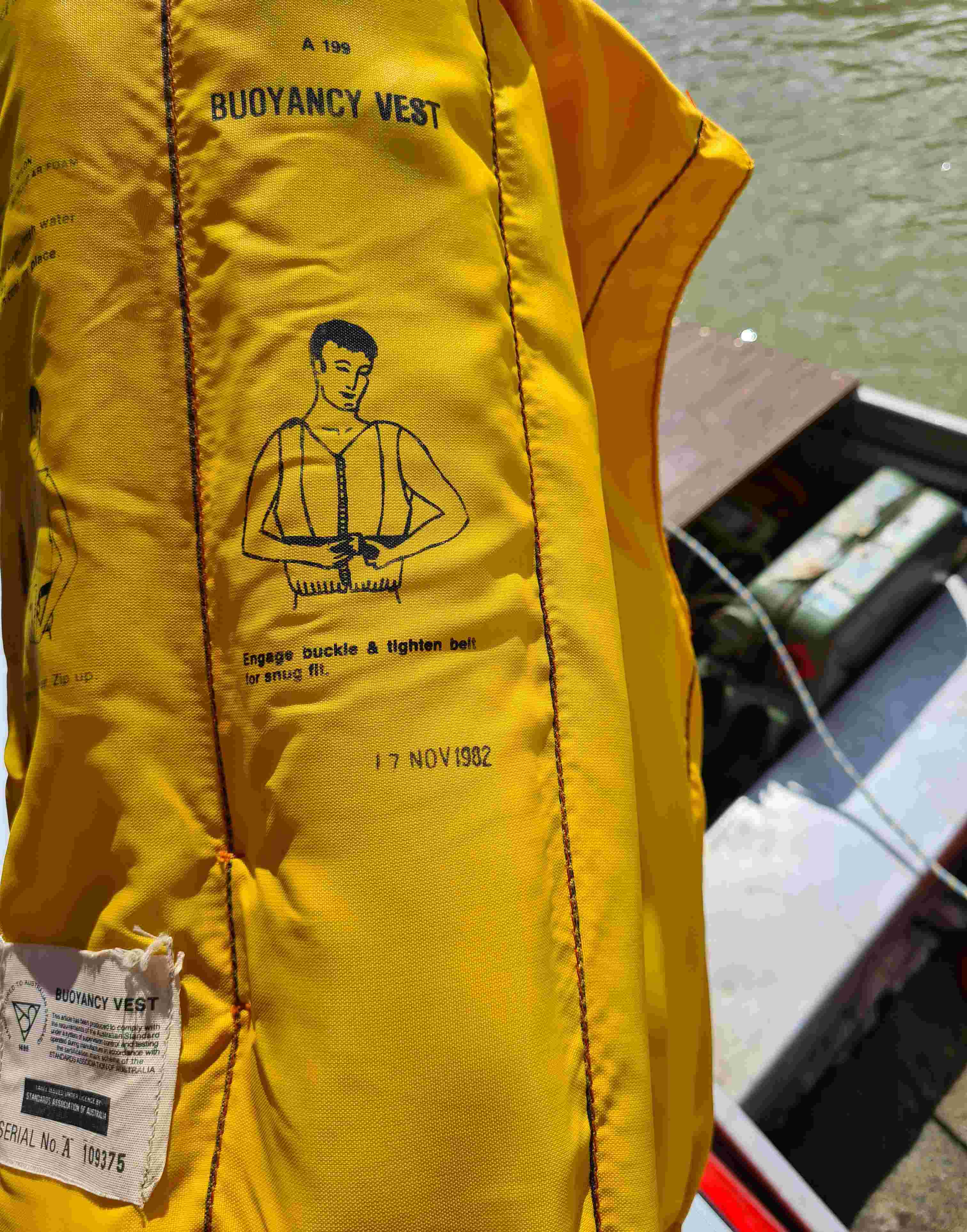 Clos up of an old yellow lifejacket showing a date of November 1982