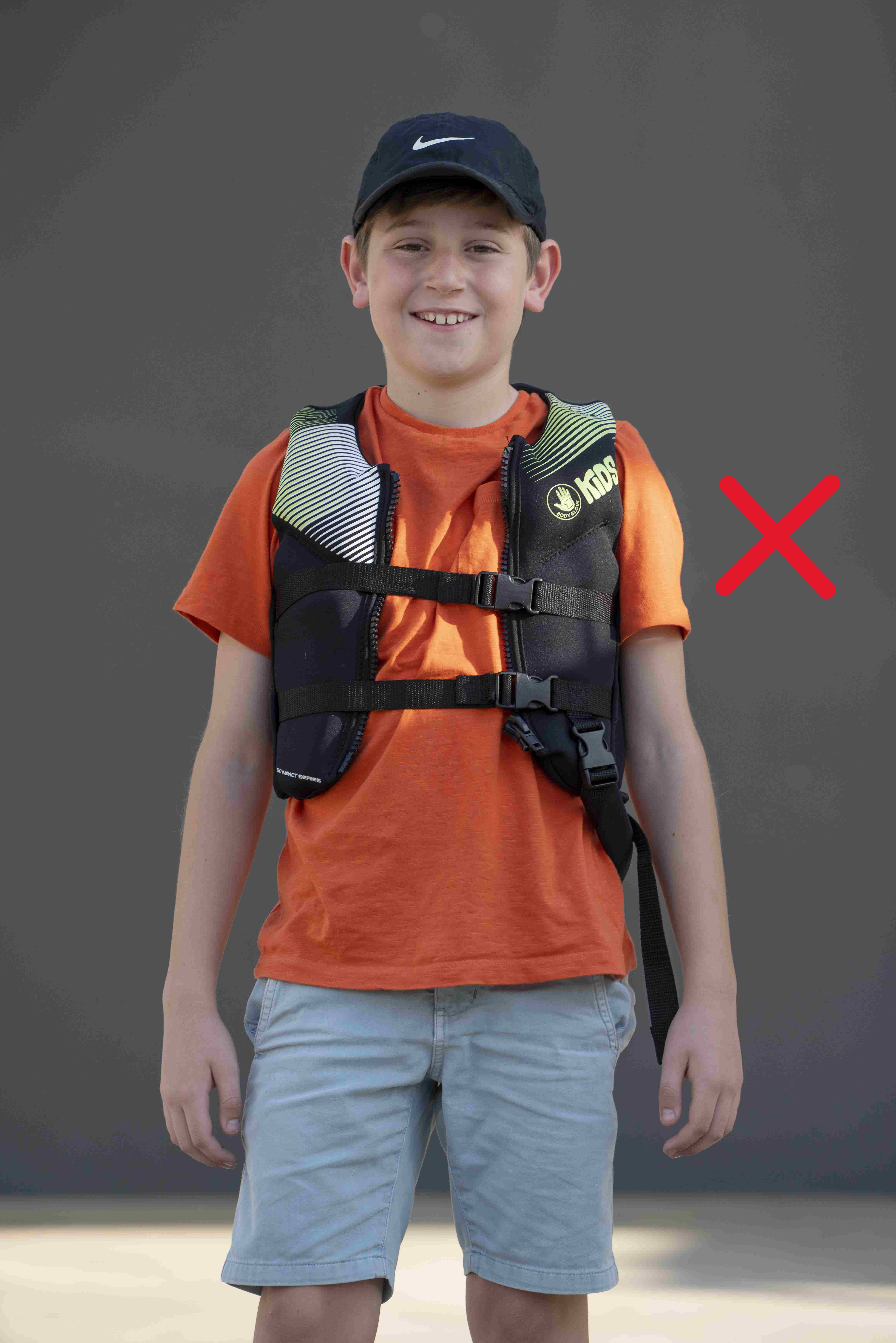Lifejacket on a child standing up that is too small